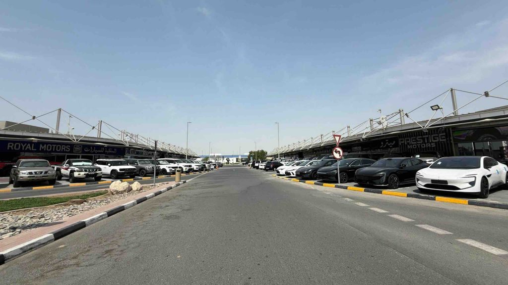 Wide view of dealership rows at Al Aweer Auto Market, one of the most popular places to buy used cars in Dubai.