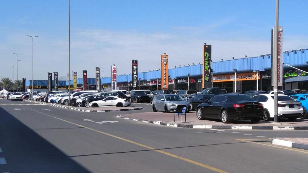 multiple dealerships and vehicles ready for sale at ras al khor car market in Dubai.